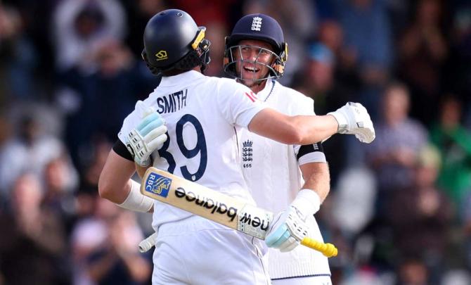 Joe Root and Jamie Smith of England celebrate winning the first Test of the five-match series against India in Leeds on Tuesday
